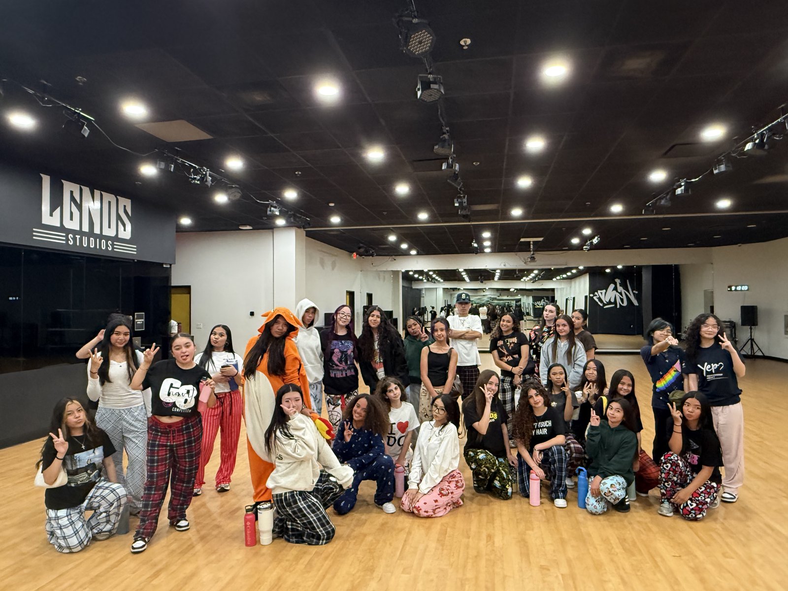 Dancers posing together for a group photo at LGNDS Studios
